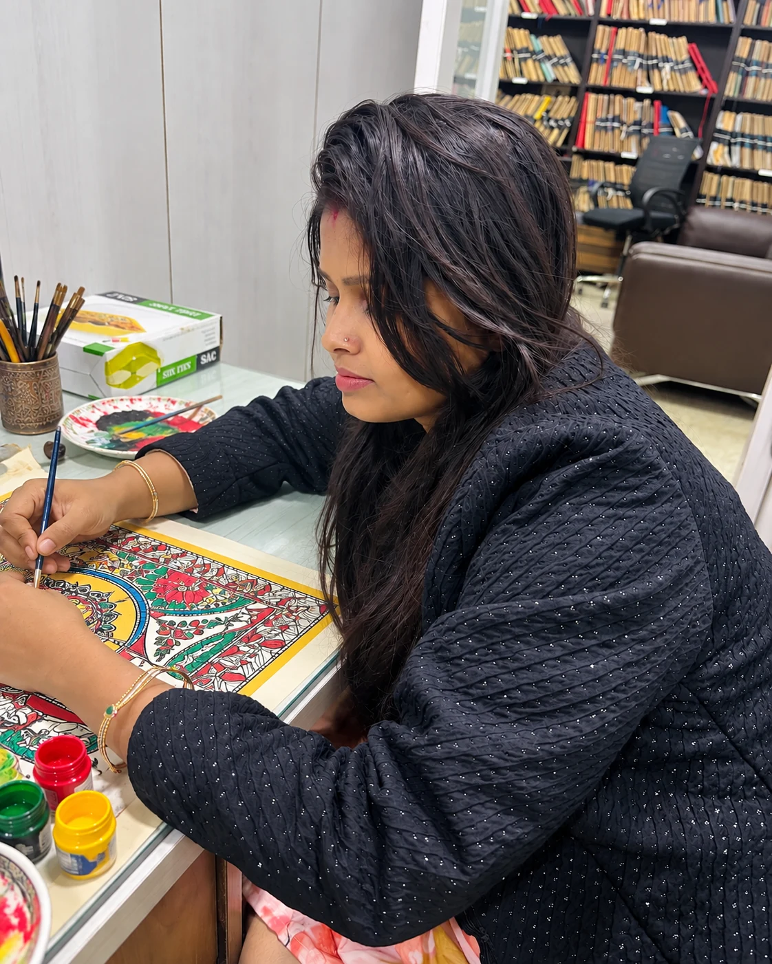 Anu Jha creating a custom artwork in her studio